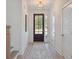 Bright and welcoming foyer with hardwood floors, a decorative rug, and elegant lighting fixture at 178 Cantona Dr, Summerville, SC 29483