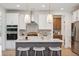 Modern kitchen with white cabinets, stainless steel appliances, stylish pendant lighting, and an island at 178 Cantona Dr, Summerville, SC 29483