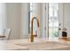 Close-up of a modern kitchen sink with a golden faucet, white countertops, and stylish design at 178 Cantona Dr, Summerville, SC 29483