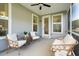 Covered patio with wicker furniture, a table, and a ceiling fan perfect for enjoying the outdoors at 178 Cantona Dr, Summerville, SC 29483