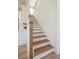 Elegant staircase with hardwood steps and white risers, connecting different levels of the home seamlessly at 178 Cantona Dr, Summerville, SC 29483