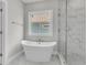Luxurious bathroom with a soaking tub and a marble-tiled shower, creating a spa-like experience at 361 Wappoo Trace Ln, Summerville, SC 29486