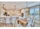 Open kitchen and dining area with a center island, a dining table, and a modern chandelier above the table at 163 Seaton Street, Summerville, SC 29486