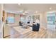 Comfortable living room featuring a ceiling fan, white wainscotting, and wood-look floors at 163 Seaton Street, Summerville, SC 29486