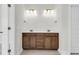 Bathroom featuring a double vanity with dark wood cabinets, white countertops, and modern lighting fixtures at 425 Grove End Rd, Moncks Corner, SC 29461