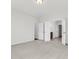 A spacious bedroom features neutral carpeting, white trim, and an open doorway to an ensuite bathroom at 425 Grove End Rd, Moncks Corner, SC 29461