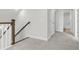 Bright hallway with wood and white banister and access to a bathroom with tile flooring at 425 Grove End Rd, Moncks Corner, SC 29461