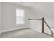 Bright hallway with wood and white banister and large window offering natural light to the carpeted space at 425 Grove End Rd, Moncks Corner, SC 29461