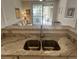 Kitchen sink with granite countertop overlooking the living area at 1600 Long Grove Dr # 628, Mount Pleasant, SC 29464