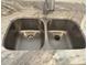Close up of a double kitchen sink and faucet set in a granite countertop at 1600 Long Grove Dr # 628, Mount Pleasant, SC 29464