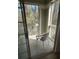 Relaxing screened patio area with a view of lush greenery, furnished with a chair at 1600 Long Grove Dr # 628, Mount Pleasant, SC 29464