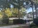 Community pool with lounge chairs, umbrellas, and mature trees at 1600 Long Grove Dr # 628, Mount Pleasant, SC 29464