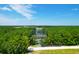 Beautiful home surrounded by lush trees, view of golf course and a long driveway at 769 Bulls Bay Blvd, Awendaw, SC 29429