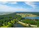 Aerial view of a property showcasing lake views, mature trees, and a golf course community at 769 Bulls Bay Blvd, Awendaw, SC 29429