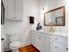 Clean bathroom with white vanity, gold fixtures, and framed mirror at 769 Bulls Bay Blvd, Awendaw, SC 29429