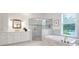 Luxurious bathroom with a soaking tub, walk-in shower, and white cabinets at 769 Bulls Bay Blvd, Awendaw, SC 29429