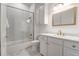 Clean bathroom with white cabinets, a shower/tub combo, and marble tile at 769 Bulls Bay Blvd, Awendaw, SC 29429