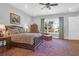 Bright bedroom with water views, a comfortable sitting area, and hardwood floors at 769 Bulls Bay Blvd, Awendaw, SC 29429
