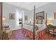 Peaceful bedroom with a four-poster bed and hardwood floors at 769 Bulls Bay Blvd, Awendaw, SC 29429