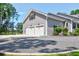 Two-car garage with gravel driveway and landscaping at 769 Bulls Bay Blvd, Awendaw, SC 29429