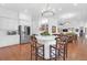 White kitchen with large island, stainless steel appliances, and hardwood floors at 769 Bulls Bay Blvd, Awendaw, SC 29429