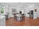 Open kitchen with white cabinets, island, and hardwood floors at 769 Bulls Bay Blvd, Awendaw, SC 29429