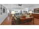 Spacious living room with hardwood floors, built-in shelving, and a ceiling fan at 769 Bulls Bay Blvd, Awendaw, SC 29429