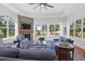 Living room with stone fireplace, hardwood floors and water views at 769 Bulls Bay Blvd, Awendaw, SC 29429
