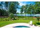 Lush backyard with pool, lake view, and patio at 769 Bulls Bay Blvd, Awendaw, SC 29429
