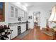 Wet bar with granite countertop, wine cooler, and white cabinetry at 769 Bulls Bay Blvd, Awendaw, SC 29429