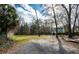 Expansive backyard area featuring a storage shed and mature trees under a sunny sky at 2991 Blackfish Rd, Johns Island, SC 29455