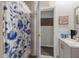 Cozy bathroom featuring floral shower curtain, modern vanity, and decorative details at 2991 Blackfish Rd, Johns Island, SC 29455