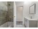 Tiled bath and shower combo with a modern vanity and gray color scheme at 2991 Blackfish Rd, Johns Island, SC 29455