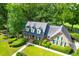 Charming brick home with manicured landscaping, dormer windows, and a well-kept lawn at 10 Trail Hollow Dr, Charleston, SC 29414