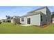 The backyard has a well-kept lawn and a small patio area perfect for outdoor seating at 2172 Macallan Blvd, Ravenel, SC 29470