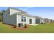 Exterior view of the home's backyard featuring green grass and a patio at 2172 Macallan Blvd, Ravenel, SC 29470