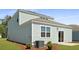 Exterior view of the home's backyard with green grass, patio and external AC unit at 2172 Macallan Blvd, Ravenel, SC 29470