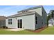 The home has a well-maintained lawn and a sliding glass door leading to a small patio area at 2172 Macallan Blvd, Ravenel, SC 29470