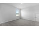 Empty bedroom featuring large window, neutral walls, and plush gray carpeting at 2172 Macallan Blvd, Ravenel, SC 29470