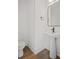 Clean half bath with a modern pedestal sink, mirror and hardwood flooring at 423 Grove End Rd, Moncks Corner, SC 29461