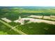 A high angle aerial view displays community development amidst a rich green forest at 5536 Bowmore Blvd, Ravenel, SC 29470