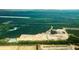 An aerial view shows homesites nestled amongst lush green trees and picturesque bodies of water at 5536 Bowmore Blvd, Ravenel, SC 29470