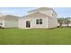 Backyard view of the home featuring a well-manicured lawn and neutral siding at 5536 Bowmore Blvd, Ravenel, SC 29470
