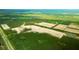 An aerial view shows new construction with ponds, close to surrounding nature at 5568 Bowmore Blvd, Ravenel, SC 29470