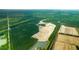 Aerial view of a new construction site with lakes and open fields at 5568 Bowmore Blvd, Ravenel, SC 29470