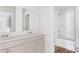 Bathroom featuring a double sink vanity, white cabinets, modern fixtures, and a walk-in shower at 5568 Bowmore Blvd, Ravenel, SC 29470