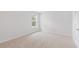 Light and airy bedroom featuring neutral carpet, white trim, a window overlooking nature, and ample natural light at 5568 Bowmore Blvd, Ravenel, SC 29470