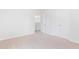 Bright bedroom with neutral carpet, white walls, closet and entryway at 5568 Bowmore Blvd, Ravenel, SC 29470