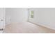 Well-lit bedroom with neutral carpet, white trim, and a window overlooking construction at 5568 Bowmore Blvd, Ravenel, SC 29470