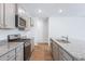 Well-equipped kitchen with stainless steel appliances, granite countertops, and gray cabinets at 5568 Bowmore Blvd, Ravenel, SC 29470